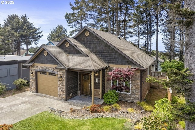 view of front of home with stone siding, an attached garage, and concrete driveway