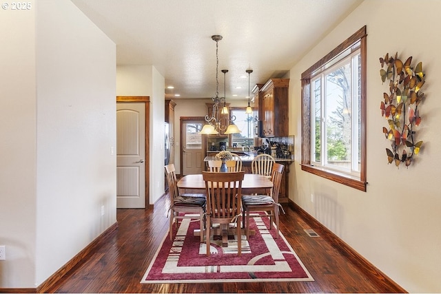 dining space with dark wood finished floors, baseboards, and recessed lighting