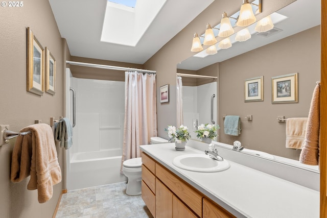 full bathroom featuring vanity, a skylight, shower / bath combination with curtain, and toilet