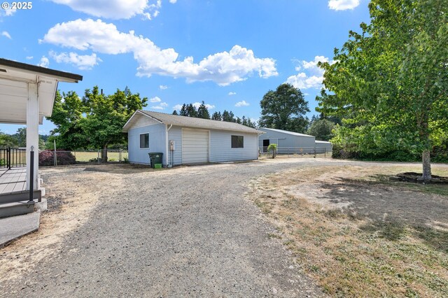 24298 Suttle Rd, Veneta, OR 97487 - view of front of house featuring a detached garage, gravel driveway, and an outdoor structure