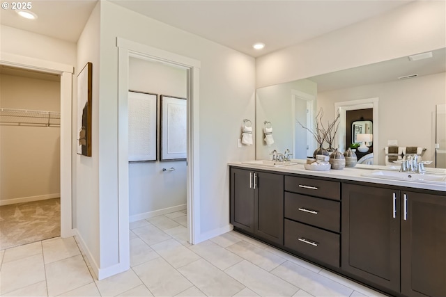 5990 Henshaw St SE, Albany, OR 97322 - bathroom with double vanity, a walk in closet, tile patterned flooring, and recessed lighting