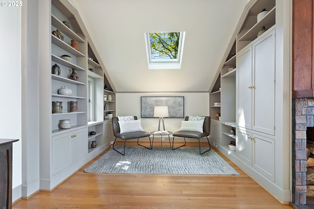 2687 NW Cornell Rd, Portland, OR 97210 - living area featuring a skylight, built in shelves, light wood-style flooring, and vaulted ceiling