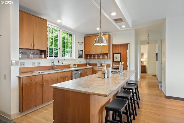 2687 NW Cornell Rd, Portland, OR 97210 - kitchen with a breakfast bar, light wood-type flooring, a kitchen island, dishwasher, and recessed lighting