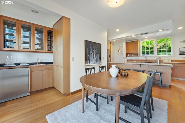 2687 NW Cornell Rd, Portland, OR 97210 - dining space featuring bar with sink, light wood-type flooring, and recessed lighting