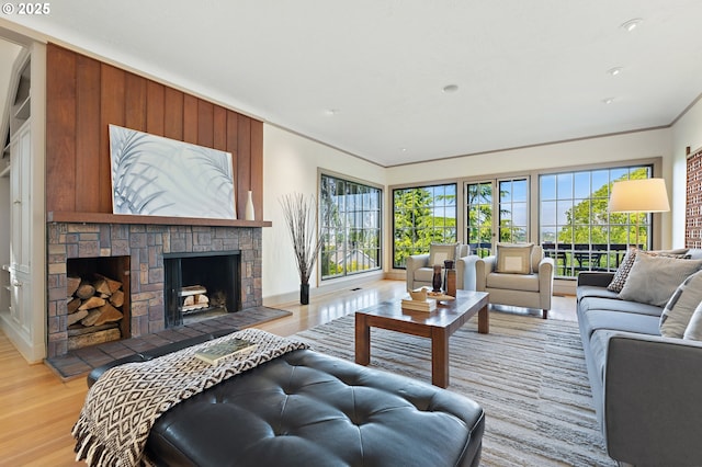 2687 NW Cornell Rd, Portland, OR 97210 - living area with a stone fireplace, ornamental molding, plenty of natural light, and light wood-style flooring