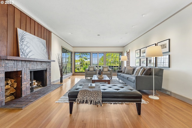2687 NW Cornell Rd, Portland, OR 97210 - living area featuring wood finished floors, a fireplace with raised hearth, and ornamental molding