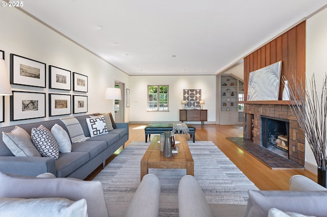 2687 NW Cornell Rd, Portland, OR 97210 - living room with built in shelves, light wood-type flooring, and a fireplace with raised hearth
