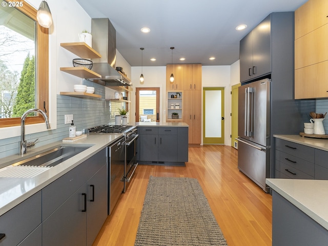 kitchen featuring high end appliances, light countertops, decorative light fixtures, and open shelves