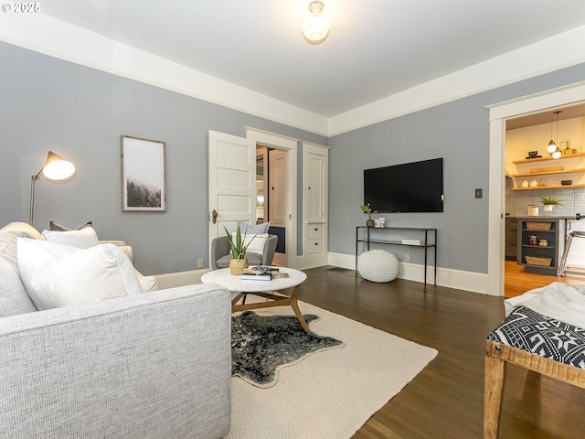 living area with dark wood-style floors and baseboards