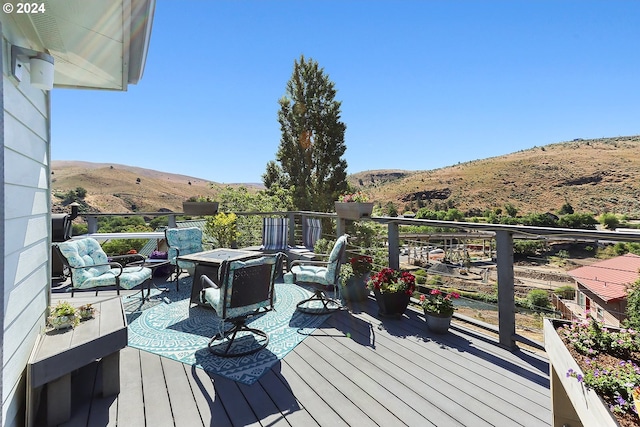 wooden deck featuring a mountain view and an outdoor living space