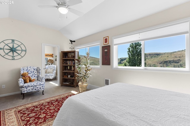 carpeted bedroom with lofted ceiling, ceiling fan, visible vents, and baseboards