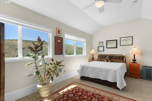 carpeted bedroom with lofted ceiling, baseboards, and a ceiling fan