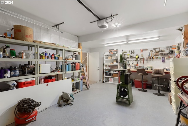 garage with a workshop area and a garage door opener