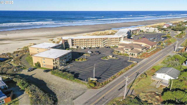 birds eye view of property with a beach view and a water view