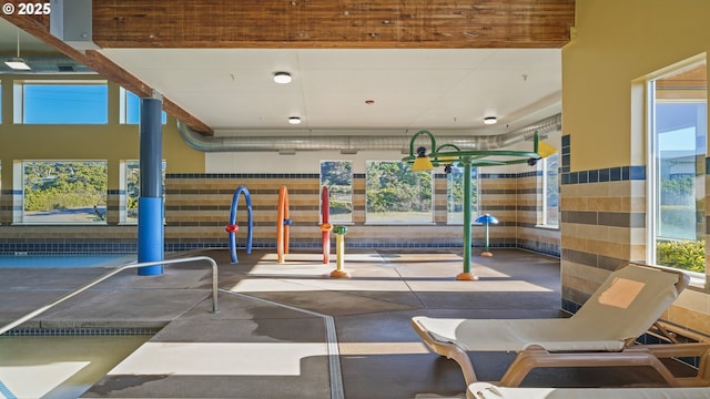 exercise room with tile walls