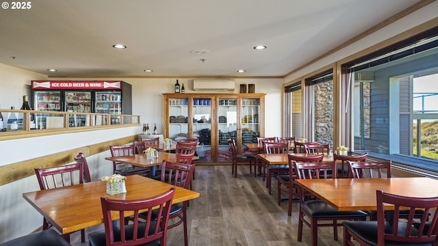 dining room featuring ornamental molding, dark hardwood / wood-style floors, and a wall mounted AC