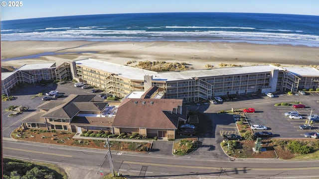 birds eye view of property with a view of the beach and a water view