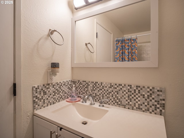 bathroom featuring vanity, decorative backsplash, and curtained shower