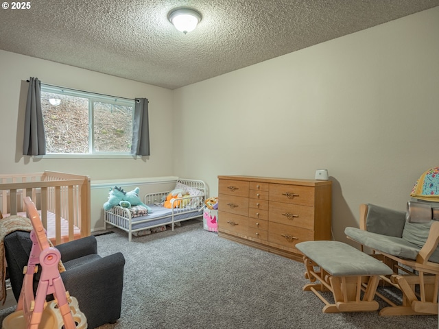 bedroom with carpet and a textured ceiling