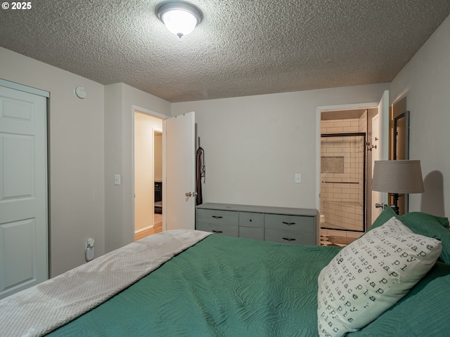 bedroom with connected bathroom and a textured ceiling