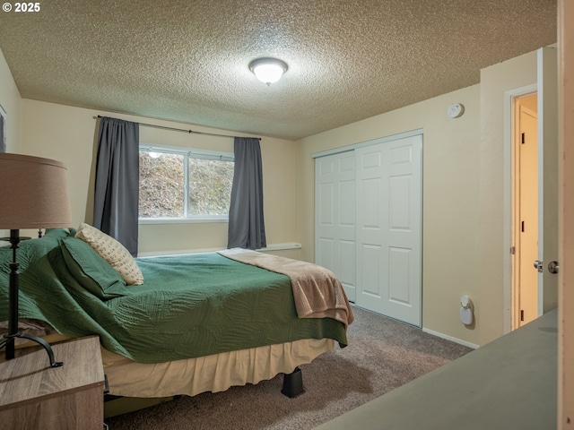 bedroom featuring a closet, a textured ceiling, and carpet