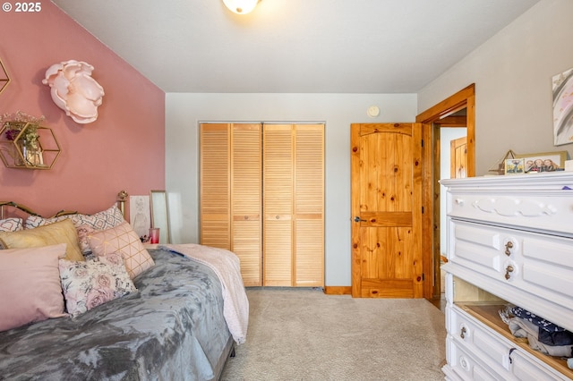 bedroom with light colored carpet and a closet