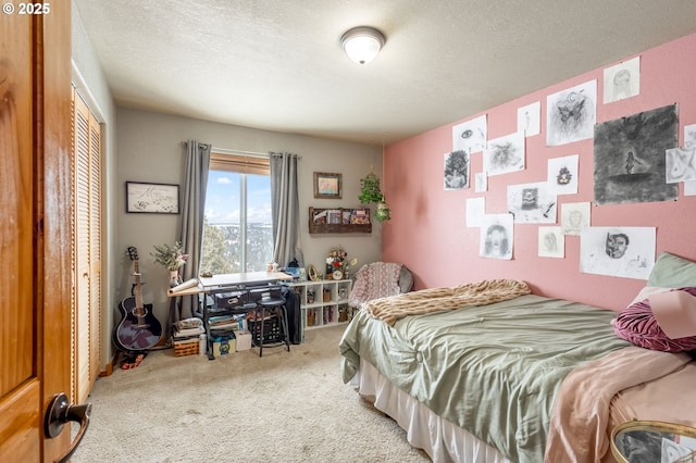 bedroom with a closet, a textured ceiling, and carpet flooring