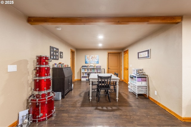 dining area with dark hardwood / wood-style floors and beamed ceiling