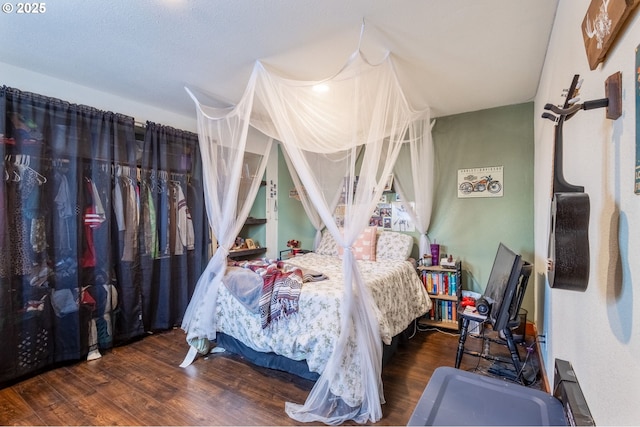 bedroom with dark hardwood / wood-style flooring