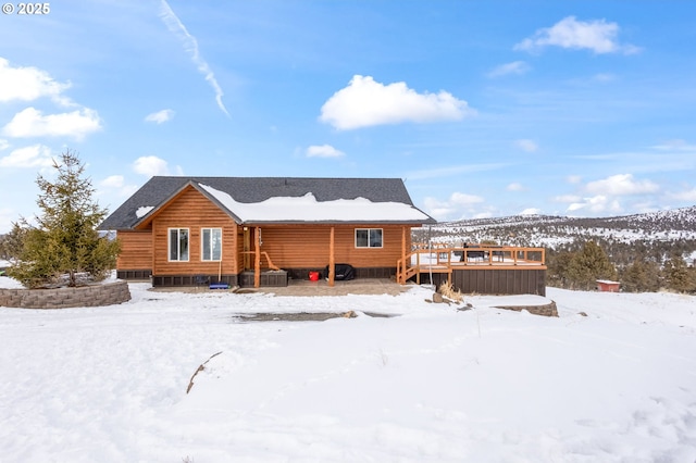 snow covered house with a deck