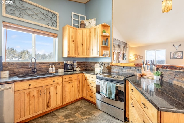 kitchen featuring vaulted ceiling, appliances with stainless steel finishes, sink, dark stone countertops, and decorative backsplash