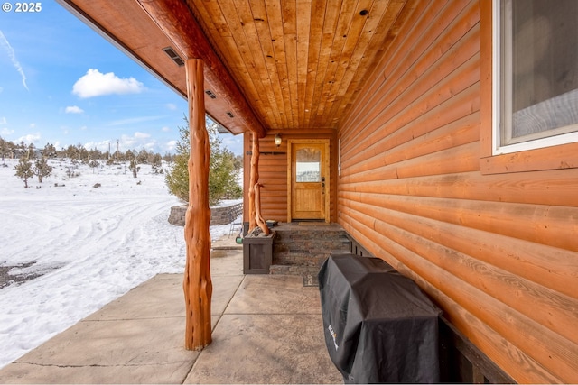 snow covered patio featuring area for grilling