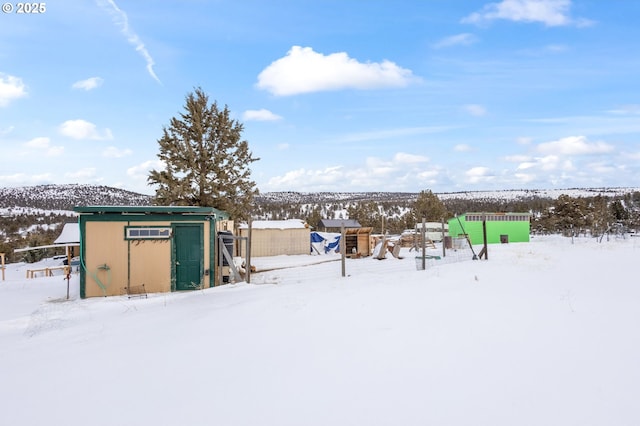 snowy yard with a mountain view