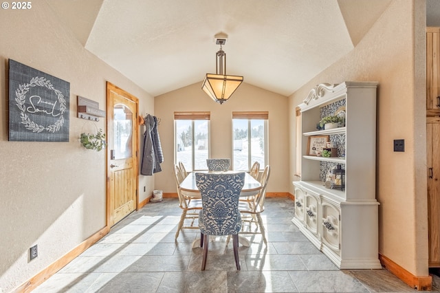 dining space with lofted ceiling