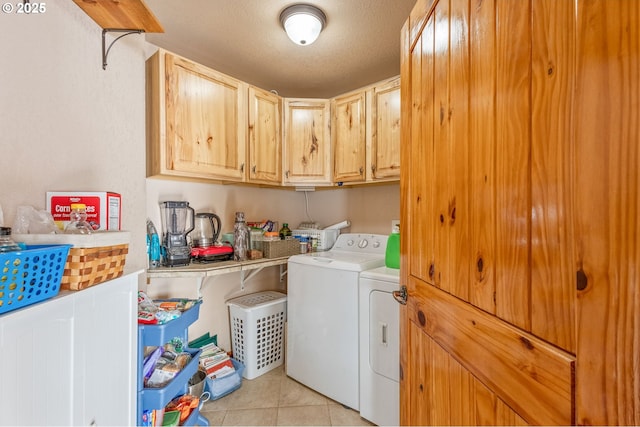 washroom featuring cabinets, light tile patterned floors, a textured ceiling, and independent washer and dryer