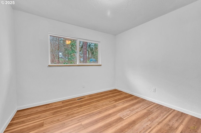 61241 Perry Creek Rd, Saint Helens, OR 97051 - empty room featuring visible vents, baseboards, and light wood finished floors