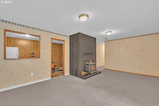 61241 Perry Creek Rd, Saint Helens, OR 97051 - unfurnished living room with baseboards, carpet floors, and a wood stove