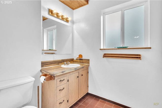 61241 Perry Creek Rd, Saint Helens, OR 97051 - half bath with tile patterned flooring, toilet, vanity, and baseboards