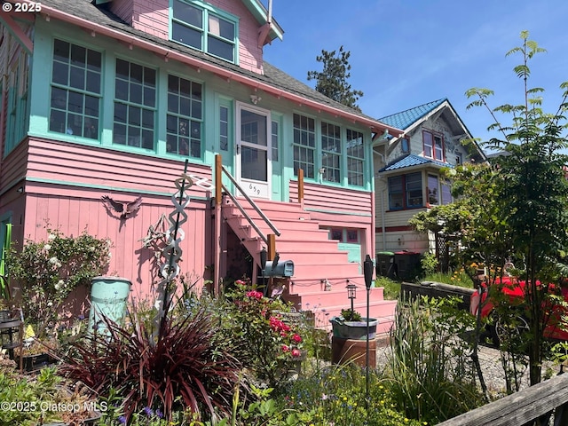 659 Florence Ave, Astoria, OR 97103 - back of property featuring stairway, a sunroom, and a shingled roof