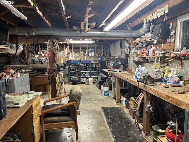 interior space featuring concrete flooring and a workshop area