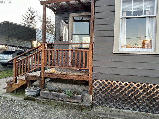 wooden deck featuring a carport