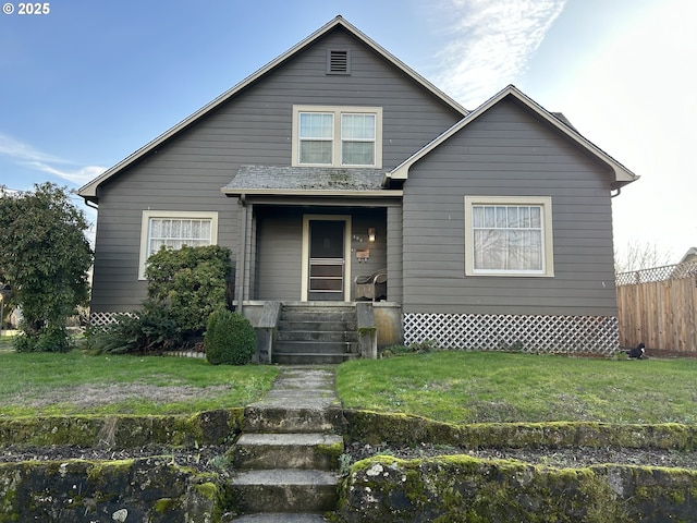 bungalow with a front yard and covered porch