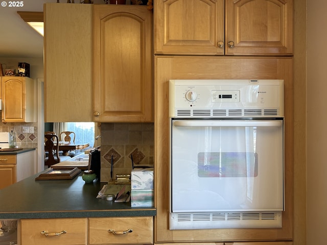 kitchen with backsplash and oven