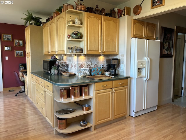 kitchen featuring light brown cabinetry, tasteful backsplash, built in desk, white refrigerator with ice dispenser, and light hardwood / wood-style floors