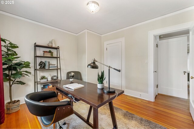 office featuring baseboards, ornamental molding, and light wood finished floors