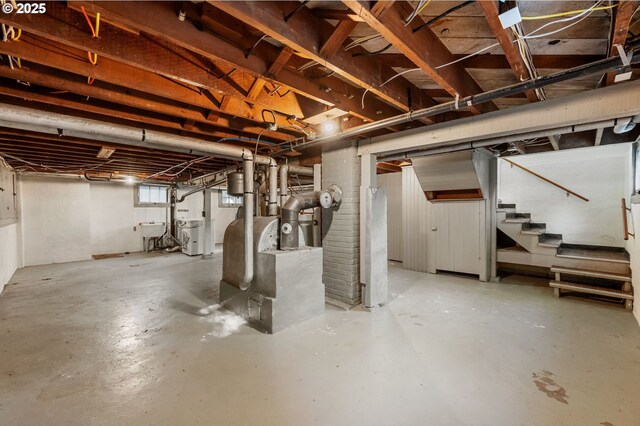 basement featuring washer / dryer, a sink, and stairway