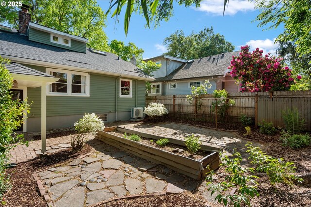 back of house with a chimney, ac unit, fence, a patio, and a shingled roof
