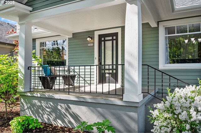 view of exterior entry featuring a porch