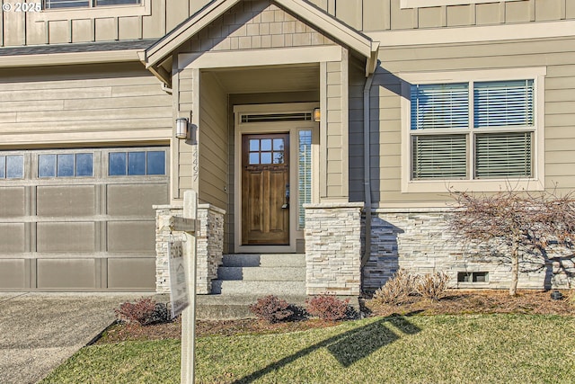 doorway to property with a garage