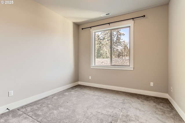 spare room featuring light carpet